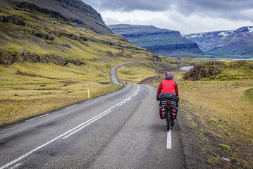 Fototapeta premium Cyclist on a Route 1 called Hringvegur near Djupivogur village in Iceland