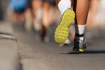 Marathon running race, people feet on city road	
