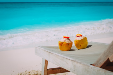 two coconut drinks on tropical beach vacation