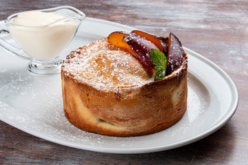 Homemade pie with whole plums from shortbread-almond dough.