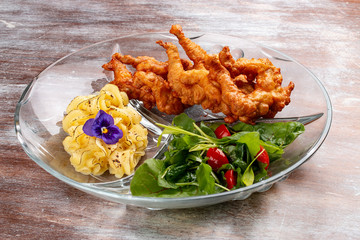 Frog legs crispy with mashed potatoes. Classic retro Russian dish
