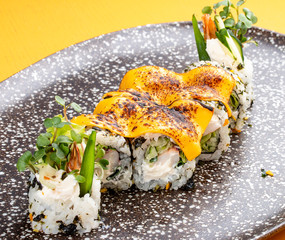 Sushi roll with crab under melted cheese. Sushi trend. Creative food. © GrumJum