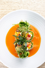 Salmon roll with Philadelphia cheese and pickled pumpkin, in rice paper with daikon and Ponzu sauce. Pan-Asian dish.