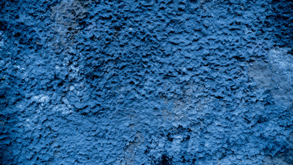 Texture of peeling bright green paint on the wall.