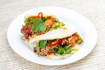 Bao..Rice steamed buns with chicken, spicy herbs and chili peppers. Pan-Asian dish.