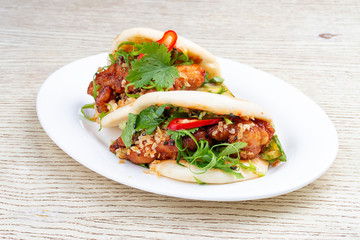 Bao..Rice steamed buns with chicken, spicy herbs and chili peppers. Pan-Asian dish.