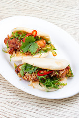 Bao..Rice steamed buns with chicken, spicy herbs and chili peppers. Pan-Asian dish.