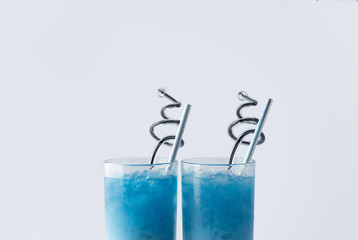 Summer refreshing beverage blue butterfly pea latte in glass on white background