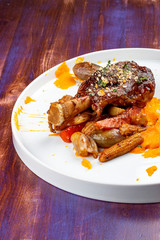 Lamb shank with demiglas sauce, carrot puree with caramelized vegetables