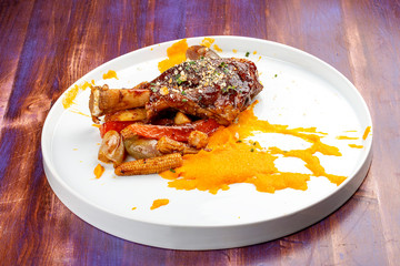 Lamb shank with demiglas sauce, carrot puree with caramelized vegetables