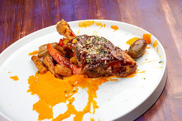 Lamb shank with demiglas sauce, carrot puree with caramelized vegetables