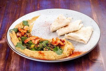 Hummus with shrimp, broccoli, zucchini, eggplant, green peas and homemade tortillas