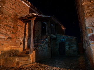 Fototapeta na wymiar dark alley with house and stone floor