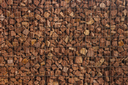 The texture of the gabion fence is made of natural stone and metal mesh