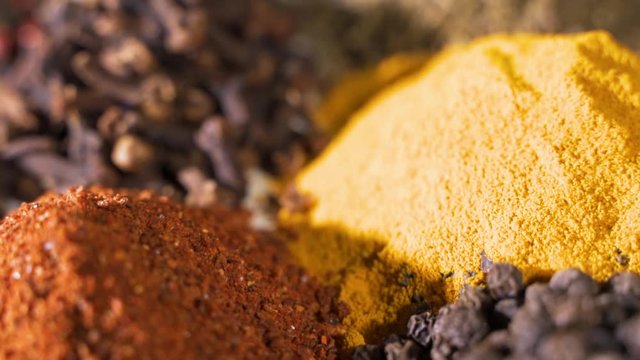 Spices. Various Indian Spices on wooden table. Assortment of Seasonings, condiments. Cooking ingredients, flavor. Slow motion video