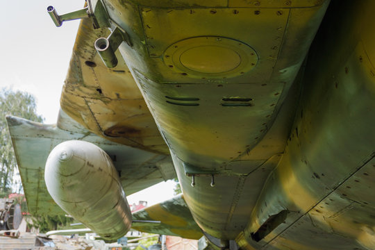 Fragment of a fuselage of an old jet fighter. Old Soviet jet fighter. Detail of an old camouflage surface with exfoliated paint on a military aircraft.