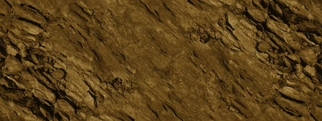 Brown grunge background. Mountain texture backdrop. Close-up. Monochrome toned rock background. Red...