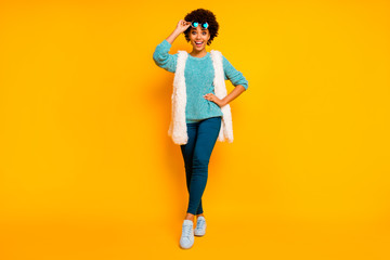Full size photo of funky crazy afro american girl touch sunglass hear fall black friday sales impressed scream wear white stylish trendy vest blue pants shoes isolated shine color backround