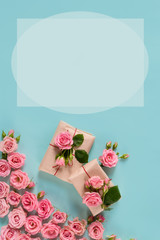 Valentine's day banner.postcard favorite.Festive wreath of roses decoration with gifts and pink roses on a blue background. copyspace.flat lay