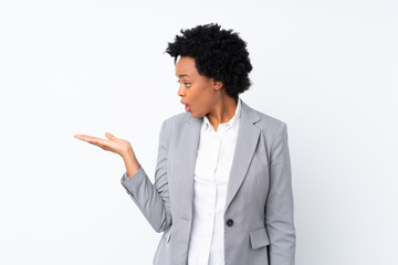 African american business woman over isolated white background holding copyspace imaginary on the palm