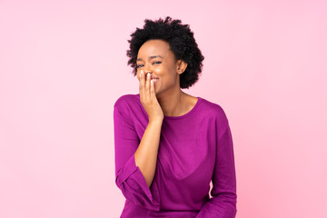 Fototapeta na wymiar African american woman over isolated pink background smiling a lot