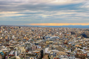 Fototapeta na wymiar Stunning aerial view over the city of Athens against cloudy sky. Famous touristic place and travel destination in Europe. Greece