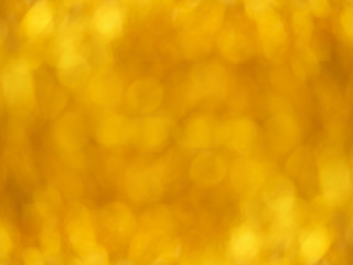 Gold bokeh. Yellow beautiful festive abstract background. Blurry light