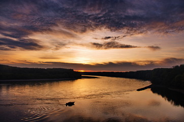 Fototapeta premium Beautiful sunset panorama over the river. Colorful twilight sky Sunset over the river