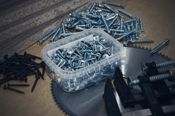 Screws, confirmations for furniture, tape measure, clamp, lie on the table. Furniture production