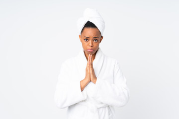 African american woman  in a bathrobe over isolated background pleading