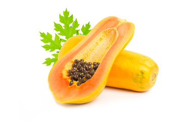 Whole and half of ripe papaya fruit with seeds on white background