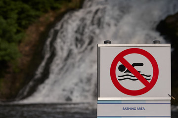 Forbidden to swim sign in this area contradiction