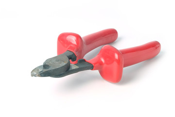 Metall wire cutters with red rubber handles isolated on white background.