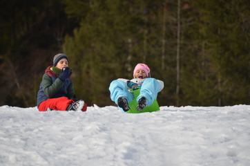 Children slide down hills 