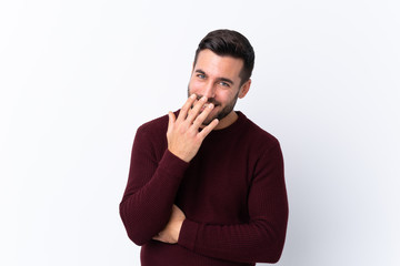 Young handsome man with beard over isolated white background smiling a lot