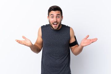 Fototapeta premium Young sport handsome man with beard over isolated white background with shocked facial expression