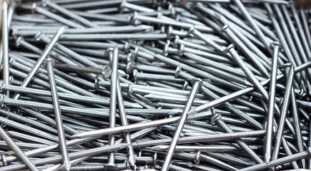 Nails pile textured background. Many nails as construction industry concept