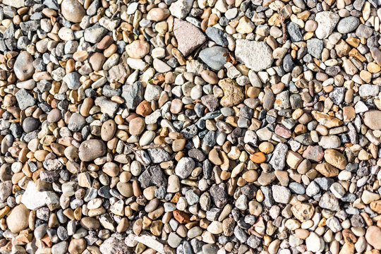 Close up image of a variety of different sized and coloured pebbles found one a stoney beach. Perfect for background use