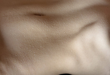 Fototapeta premium Naked belly with water drops.