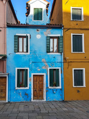 Typical house of strong colors of the island of Burano, Venice, Italy.