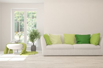 Stylish room in white color with sofa and summer landscape in window. Scandinavian interior design. 3D illustration