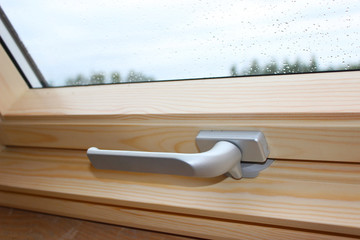 A Modern Sunroof. Handle for opening the attic window, close-up. Mansard Design Of An Attic House....