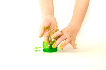 Modern toy called slime. Child playing transparent green slime. Hands holding a mucus isolated on a white background. Selective focus.