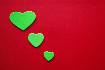 green hearts decoration on the red background for valentine's day, romantic background