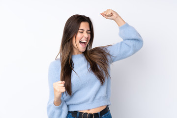 Teenager girl over isolated white background celebrating a victory