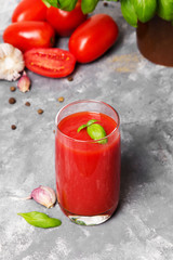 Tasty tomato juice with fresh spices, garlic, pepper and basil