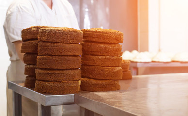 Mass production of cakes and sweets at the confectionery factory. Chefs make cakes of fresh berries and biscuit, food industry, copy space