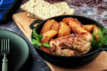 Oven-baked chicken with vegetables and herbs. Home made food. Concept for a tasty and hearty meal.