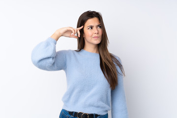 Teenager girl over isolated white background making the gesture of madness putting finger on the head