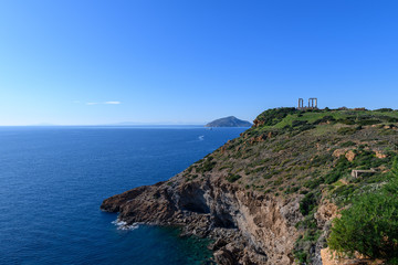 Beautiful rocky coastline and temple of Poseidon on Cape Sounion